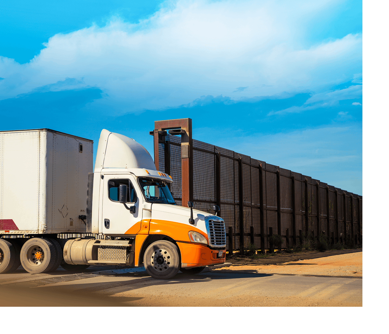 Truck near a large border wall