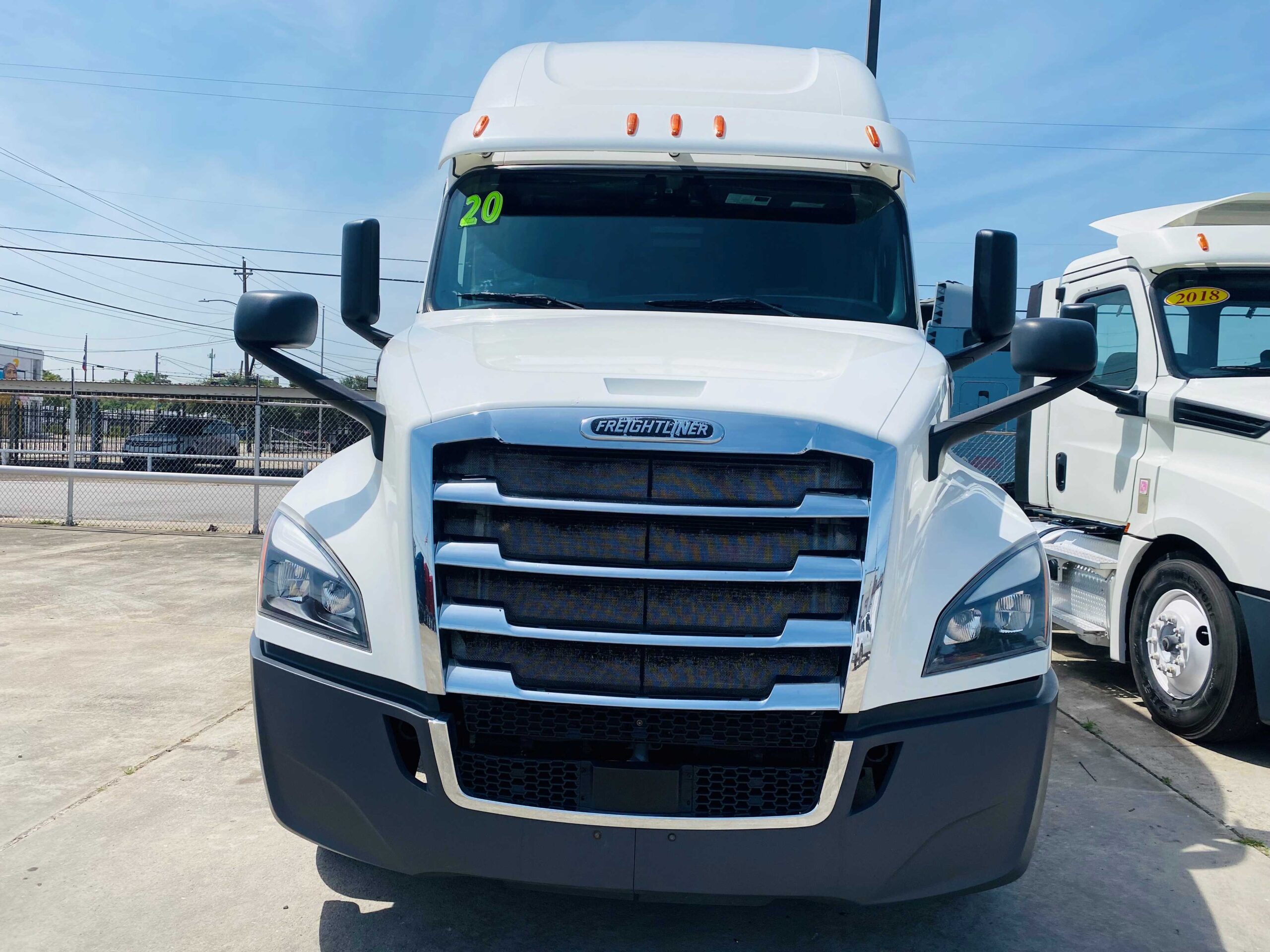 White semi-truck parked on concrete lot