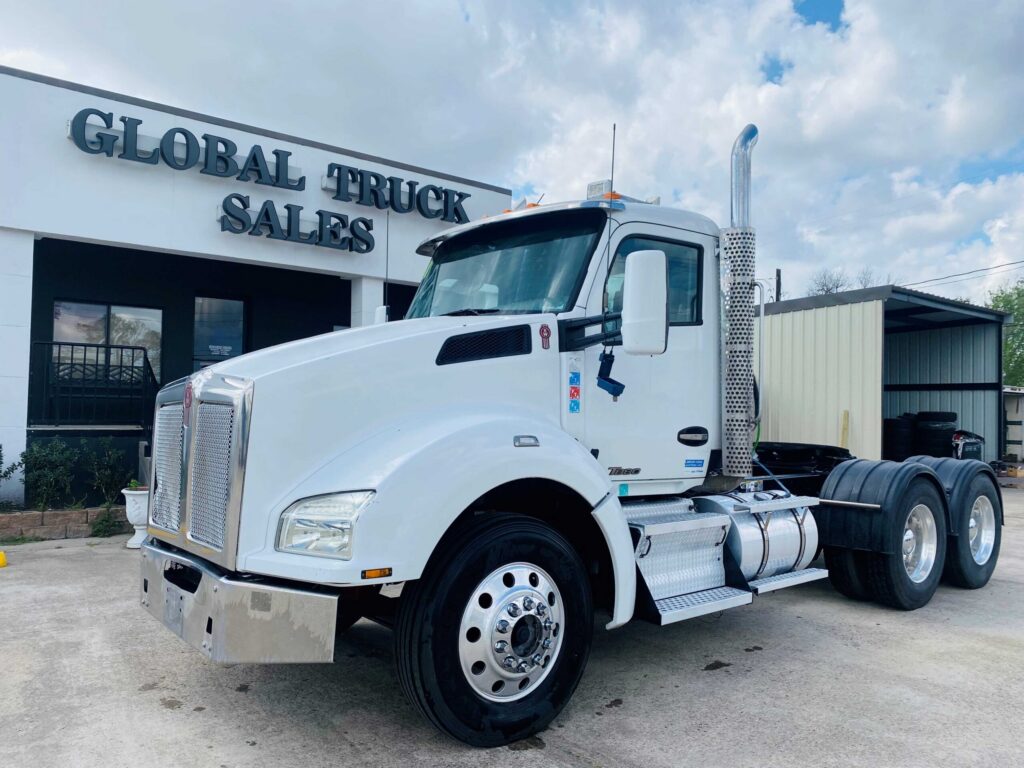 White truck parked outside dealership