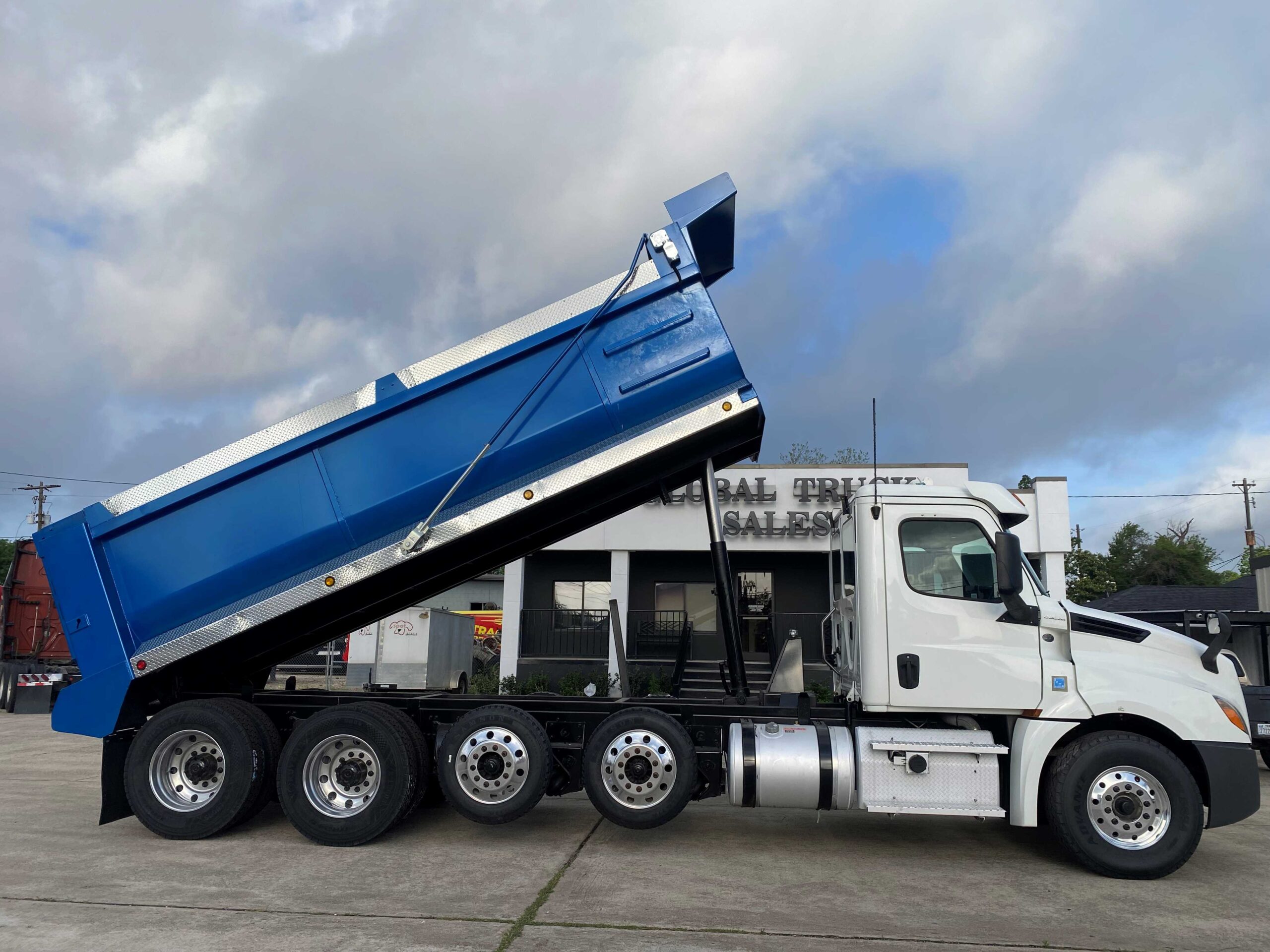 Dump truck parked, bed raised high