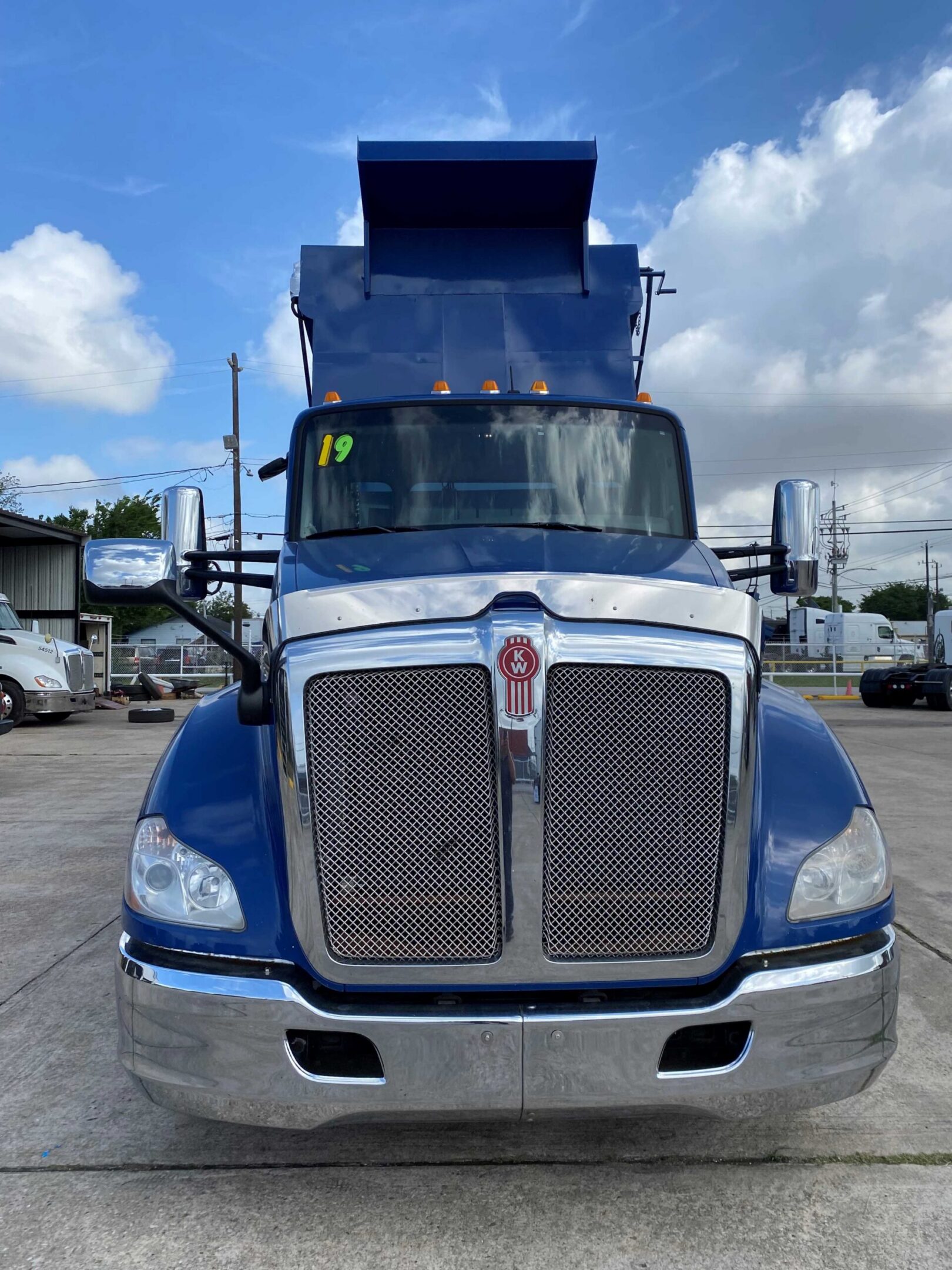 Heavy-duty blue dump truck parked