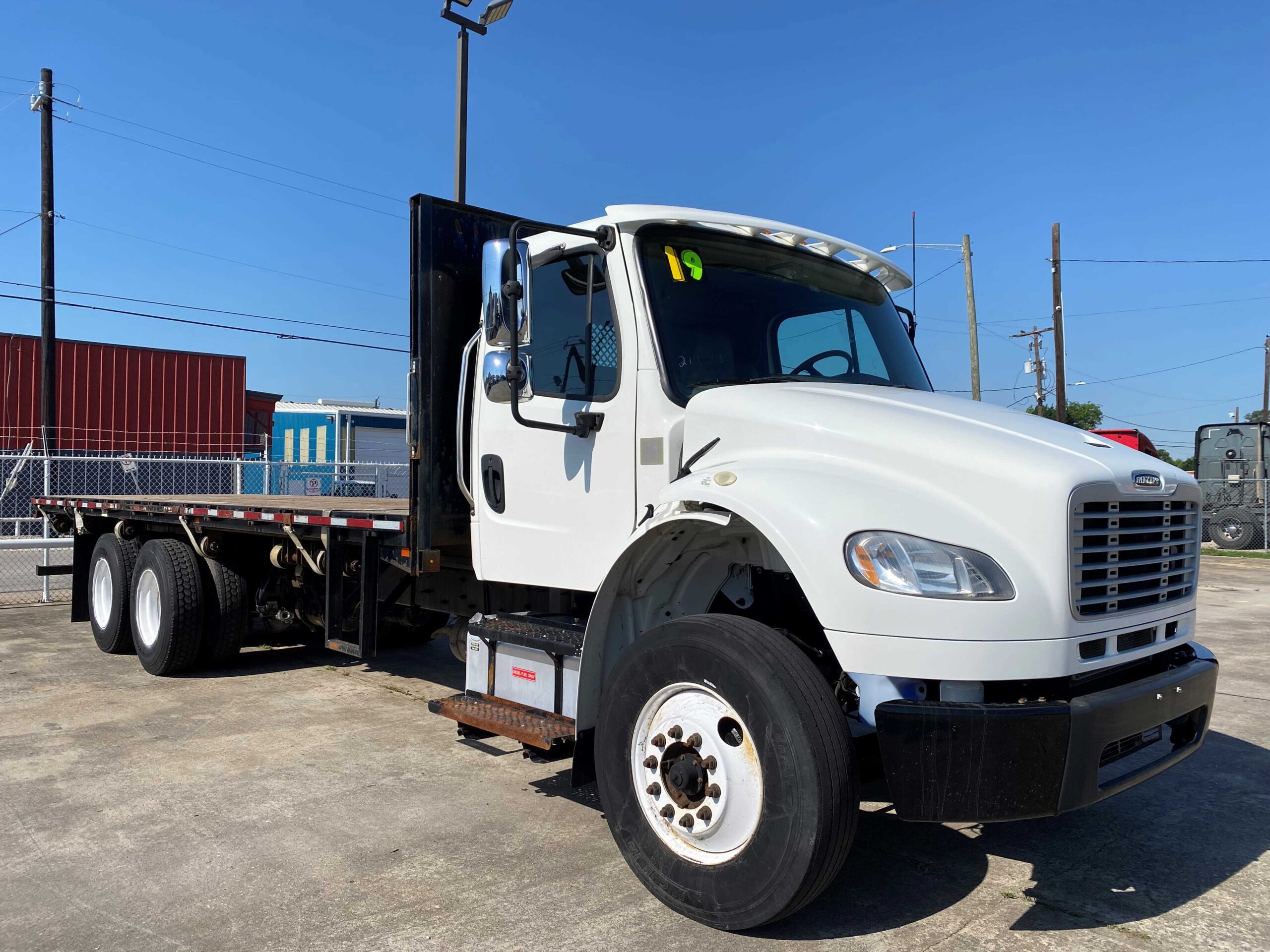Flatbed truck with clear blue sky
