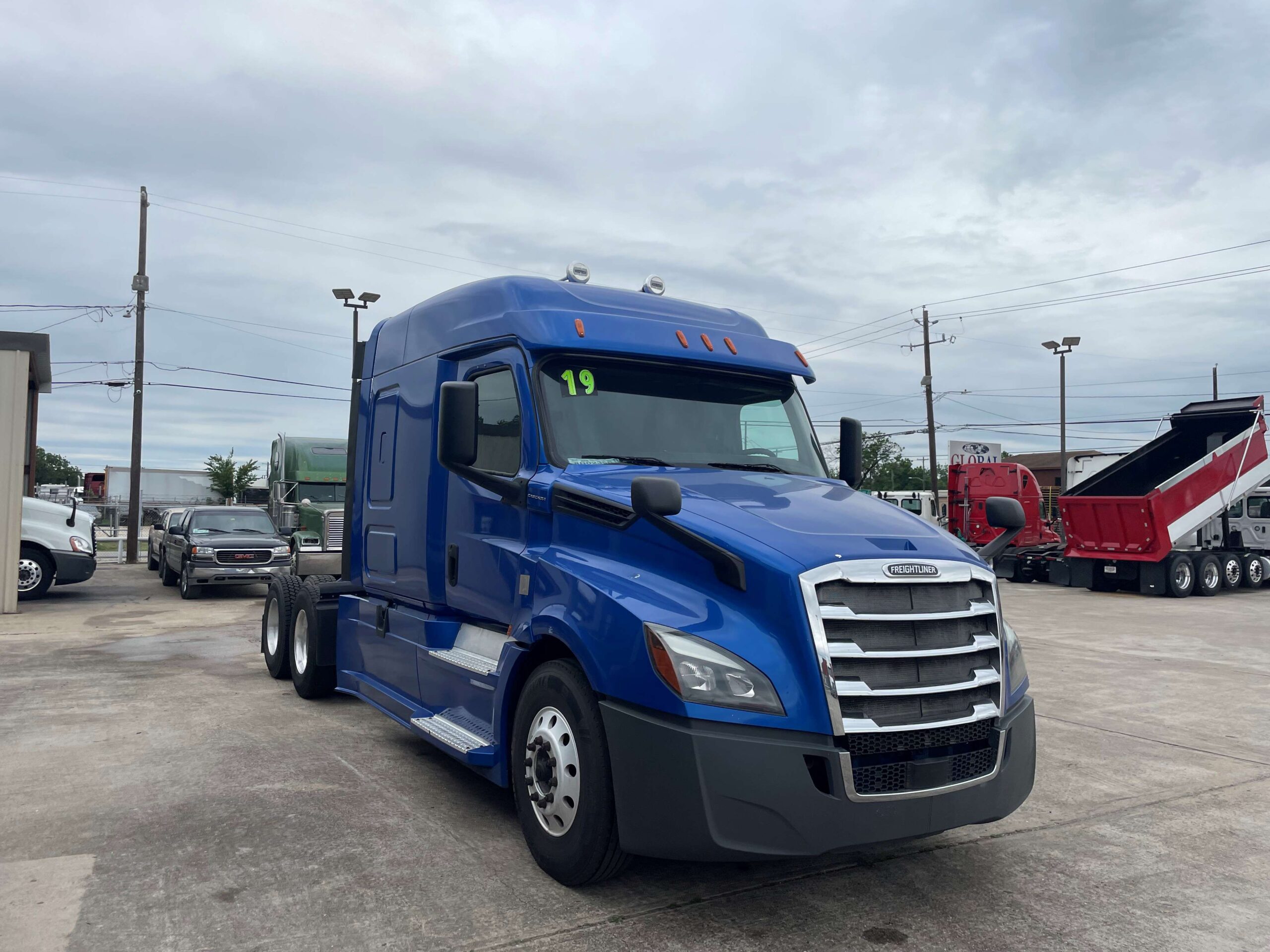 Blue freight truck on concrete surface