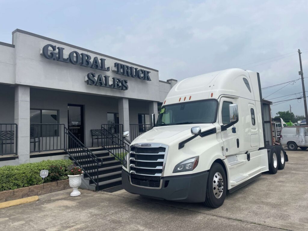 White truck parked outside sales office